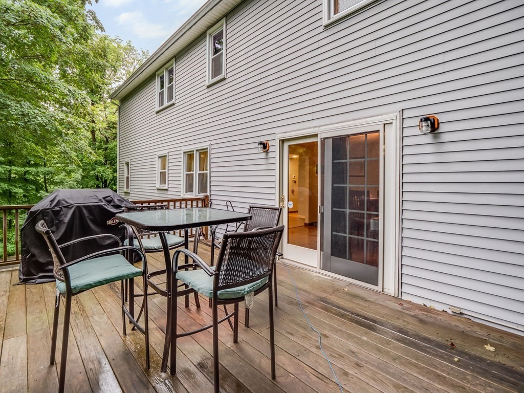145 Coburn Road Tyngsborough, MA 01879 - Photo 39 of 41 a patio with table and chairs and potted plants