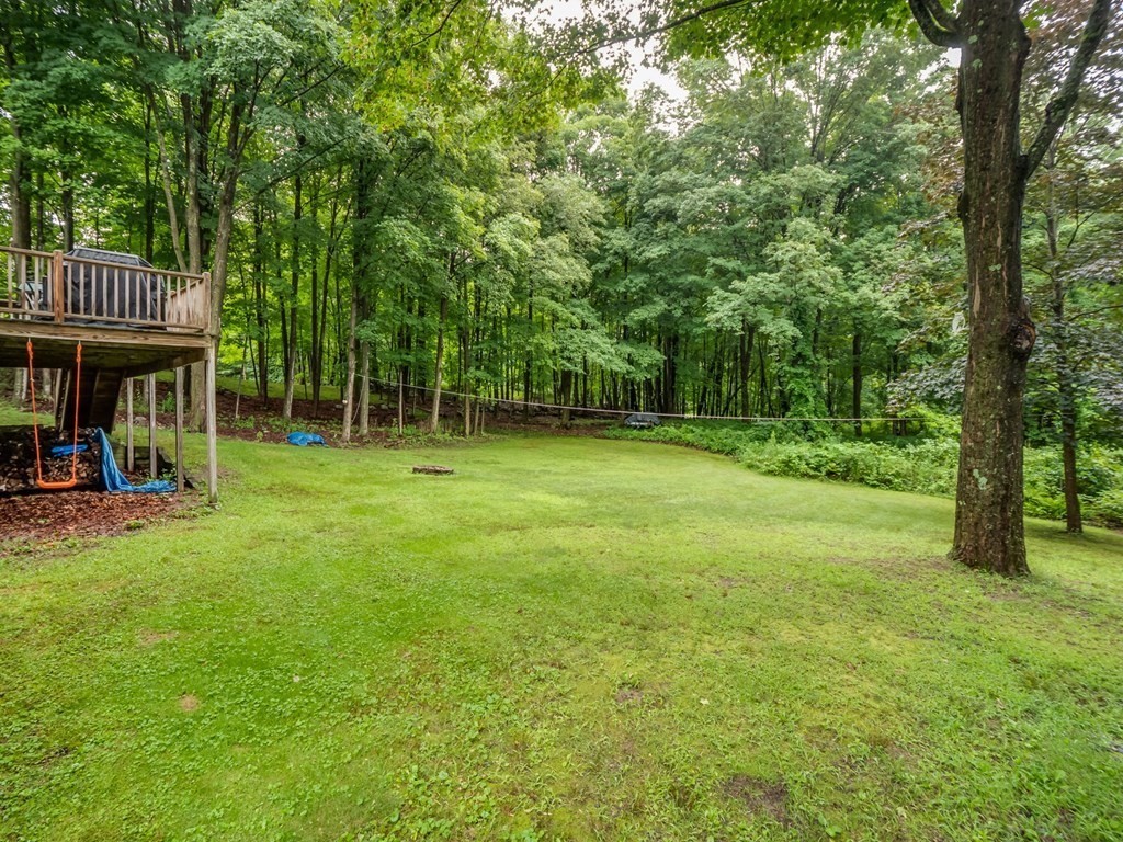 145 Coburn Road Tyngsborough, MA 01879 - Photo 40 of 41 a view of a big room with a big yard and large trees