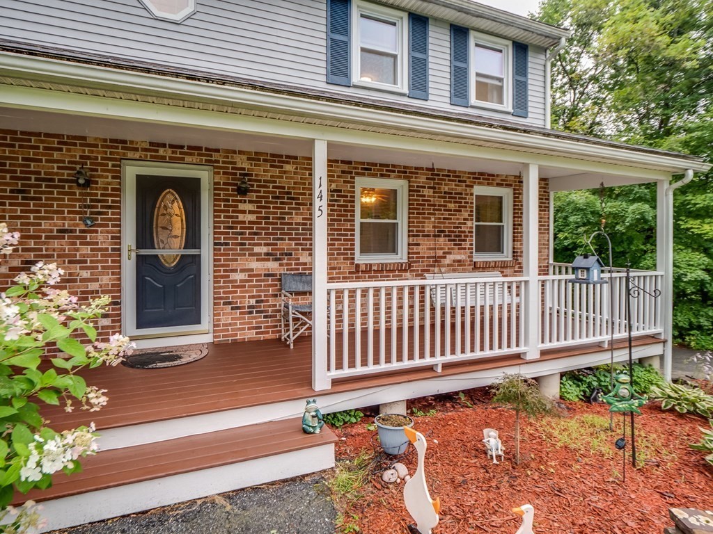 145 Coburn Road Tyngsborough, MA 01879 - Photo 4 of 41 a front view of a house with a porch