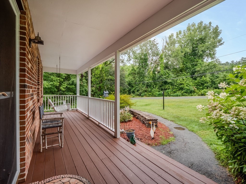 145 Coburn Road Tyngsborough, MA 01879 - Photo 5 of 41 a view of a chairs and table on the wooden deck