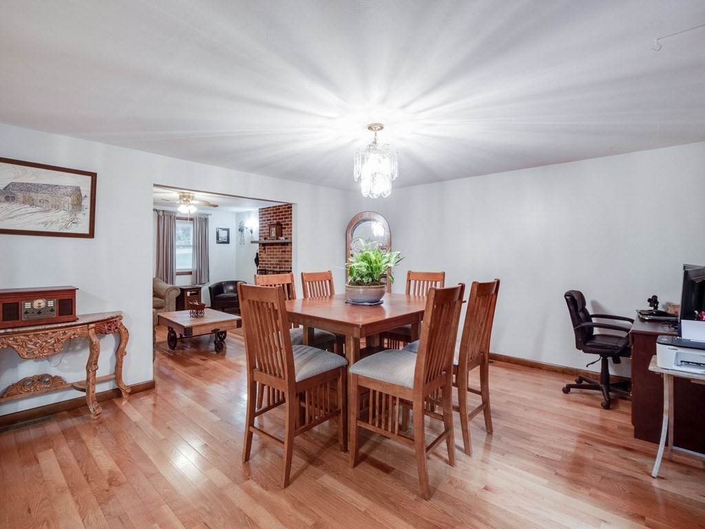 145 Coburn Road Tyngsborough, MA 01879 - Photo 10 of 41 a view of a dining room with furniture and wooden floor