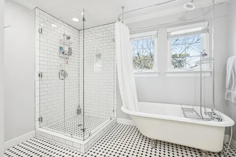 a bathroom with a shower a bathtub and a sink