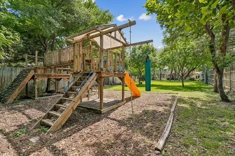 a view of outdoor space with playground and green space