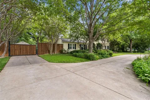 a view of backyard of house with green space