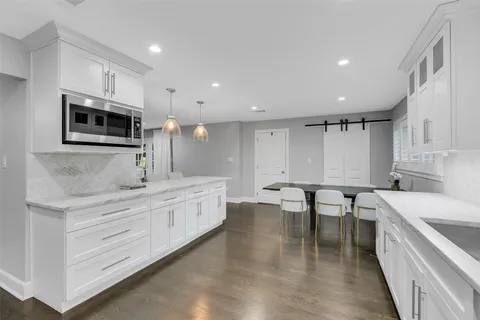 a kitchen with kitchen island a sink stainless steel appliances and cabinets