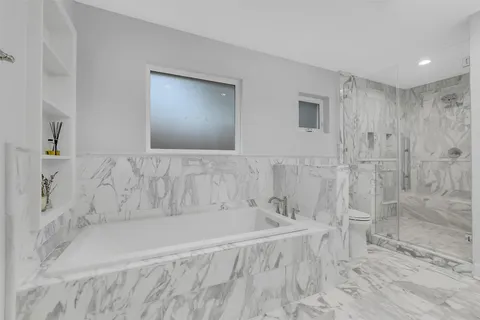 a bathroom with a double vanity sink mirror double and shower