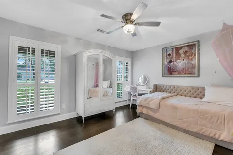 a bedroom with furniture and a book shelf