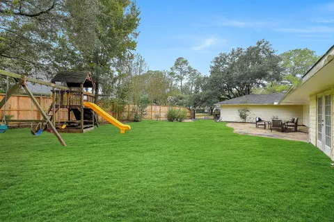 a view of a house with a yard table and chairs