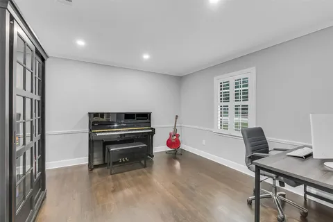 a livingroom with furniture and a piano