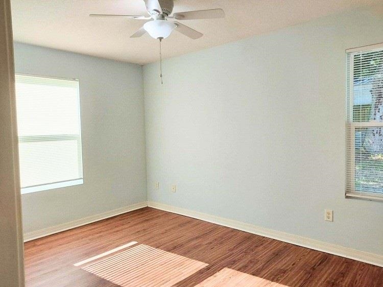 63 Anderson Street St. Augustine, FL 32084 - Photo 11 of 16 Empty room featuring healthy amount of natural light, wood finished floors, and a ceiling fan