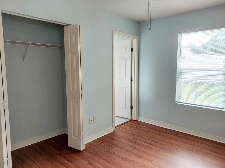 63 Anderson Street St. Augustine, FL 32084 - Photo 12 of 16 Unfurnished bedroom featuring a closet and dark wood finished floors