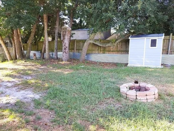 a backyard of a house with table and chairs