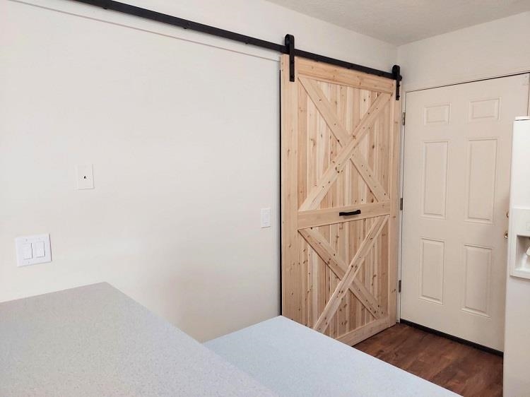 63 Anderson Street St. Augustine, FL 32084 - Photo 5 of 16 Unfurnished bedroom featuring dark wood-style floors and white refrigerator with ice dispenser