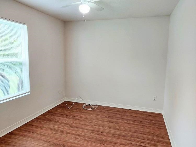 63 Anderson Street St. Augustine, FL 32084 - Photo 7 of 16 Unfurnished room with wood finished floors and a ceiling fan