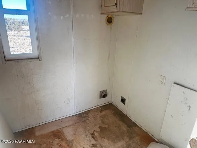 a utility room with stainless steel appliances granite countertop a sink and a cabinets