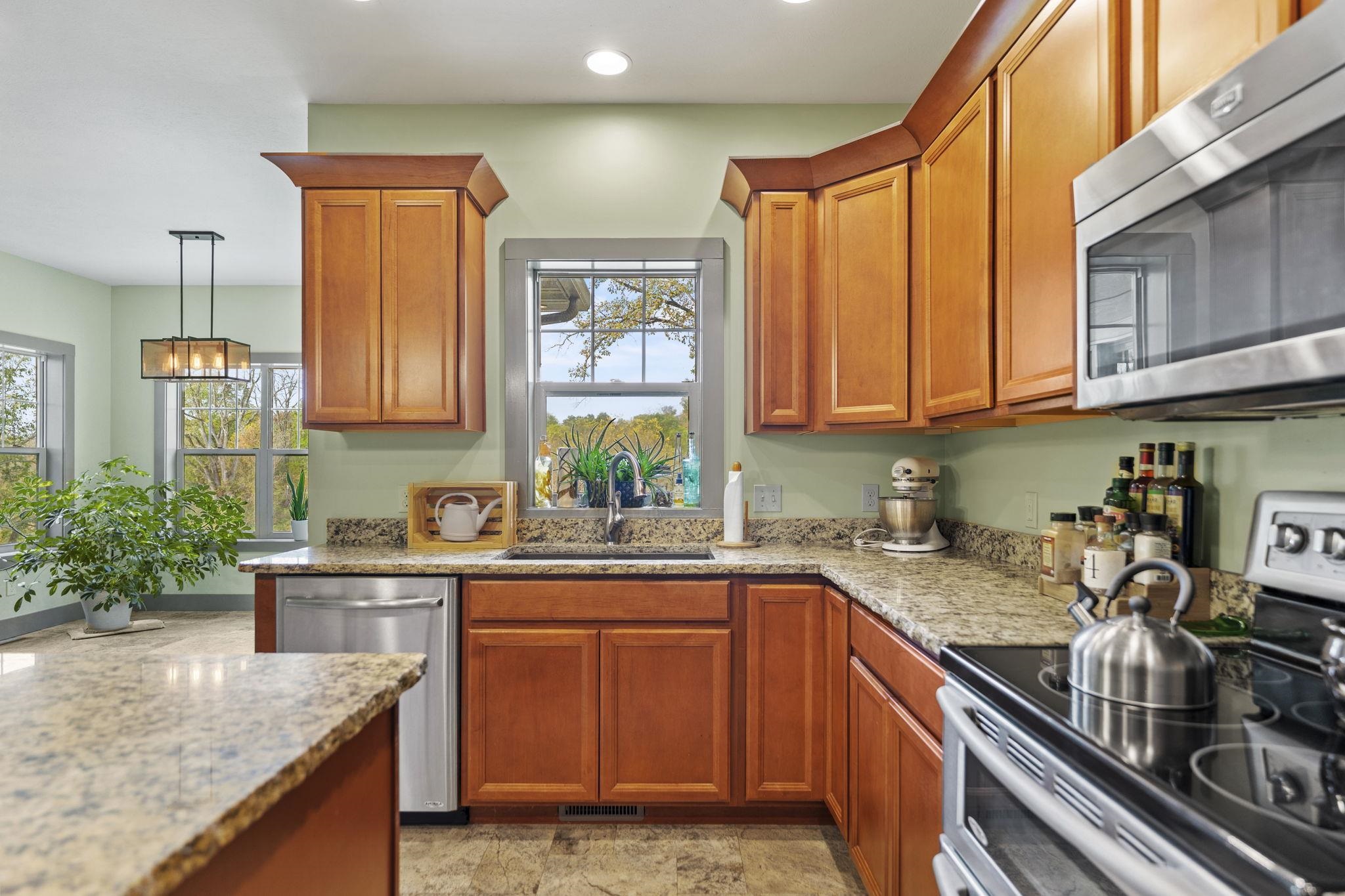 166 South Rocky Hill Road Galena, IL 61036 - Photo 11 of 57 a kitchen with granite countertop a sink a stove and cabinets