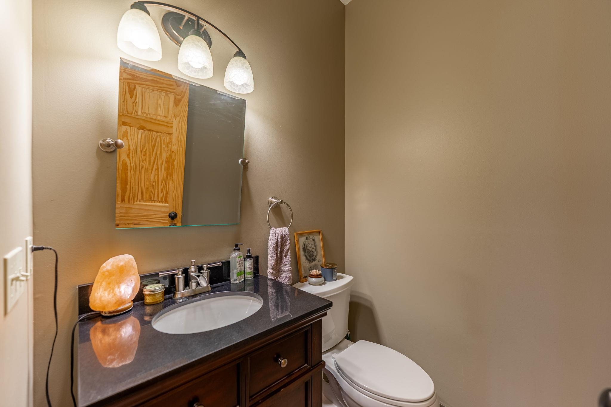 166 South Rocky Hill Road Galena, IL 61036 - Photo 14 of 57 a bathroom with a granite countertop toilet sink and mirror