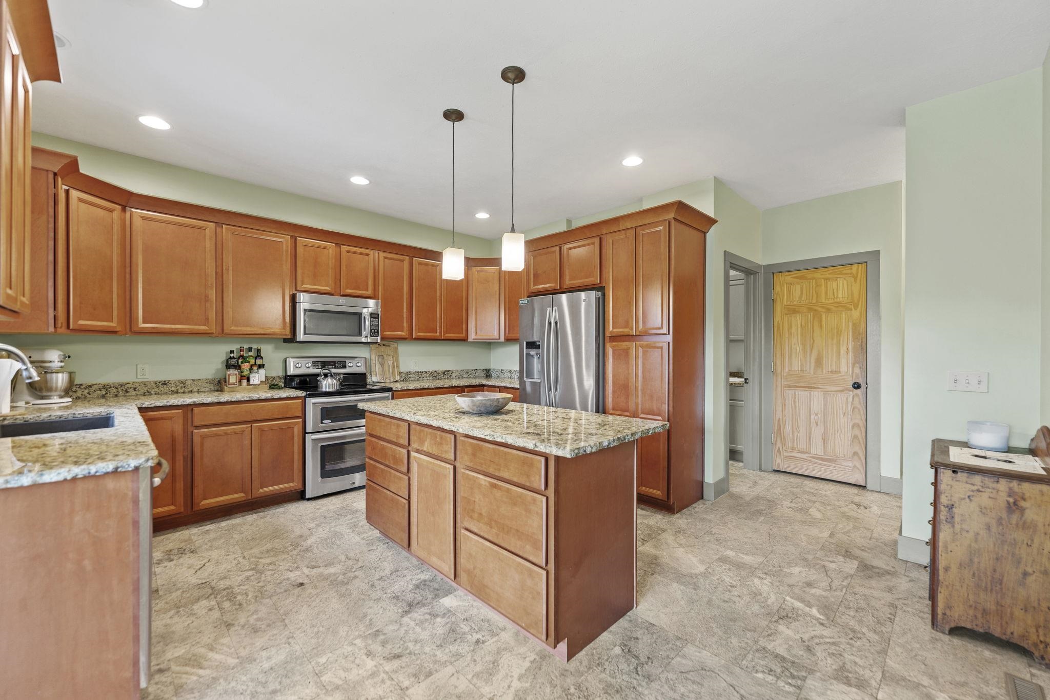 166 South Rocky Hill Road Galena, IL 61036 - Photo 9 of 57 a kitchen with stainless steel appliances granite countertop a stove refrigerator sink and microwave