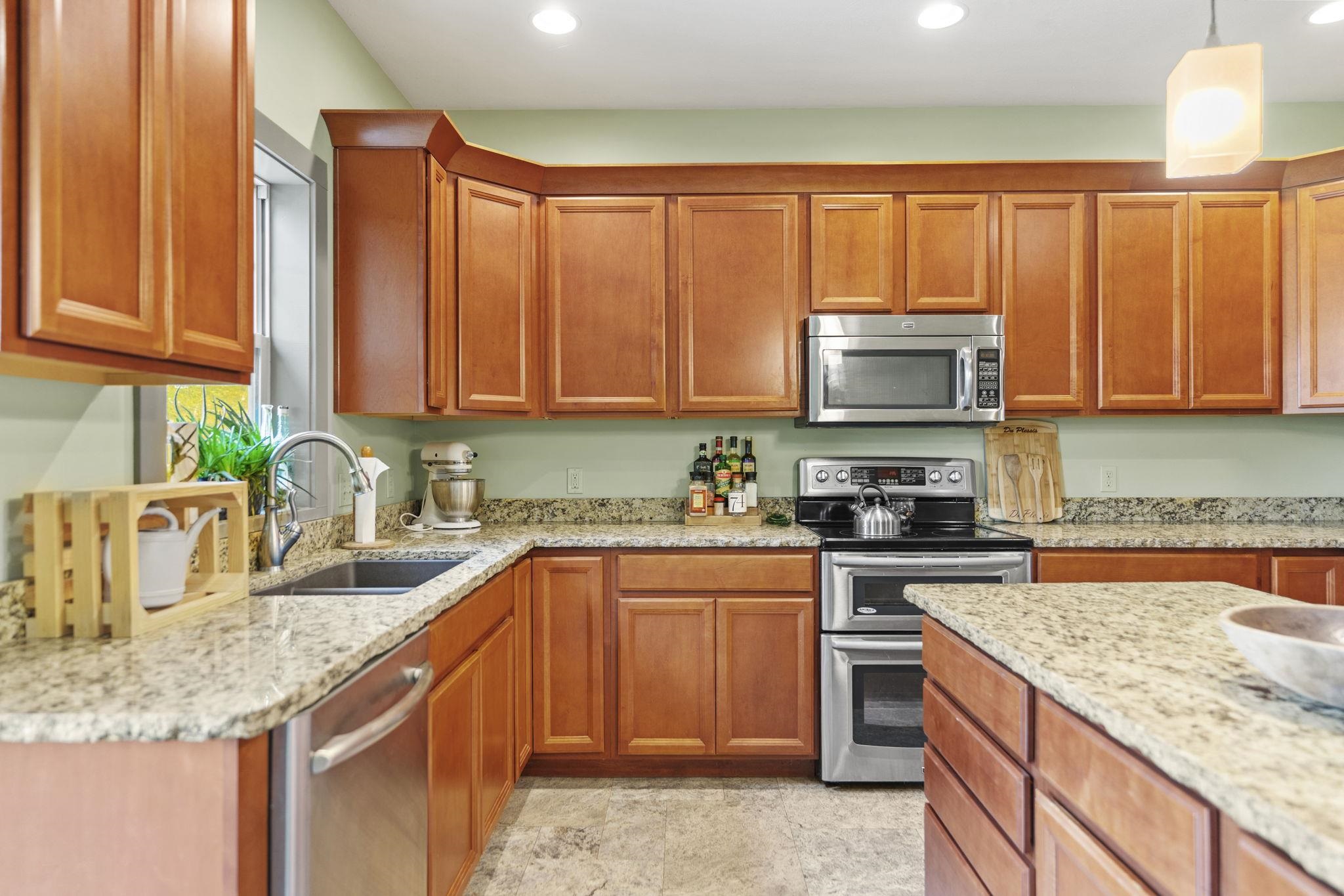 166 South Rocky Hill Road Galena, IL 61036 - Photo 10 of 57 a kitchen with stainless steel appliances granite countertop a sink stove and cabinets