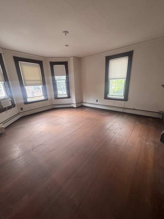 86 Chestnut Street, Unit 2 Brookline, MA 02445 - Photo 1 of 11 an empty room with wooden floor and windows