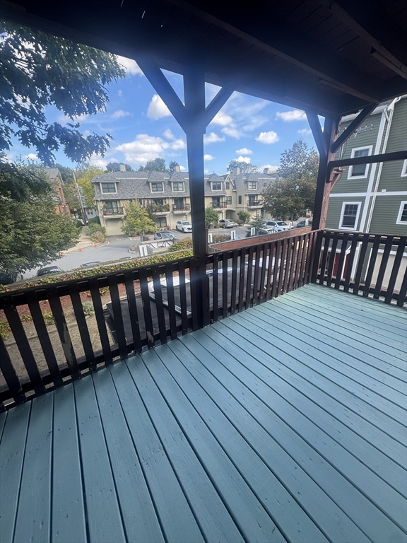 86 Chestnut Street, Unit 2 Brookline, MA 02445 - Photo 11 of 11 a balcony with wooden floor
