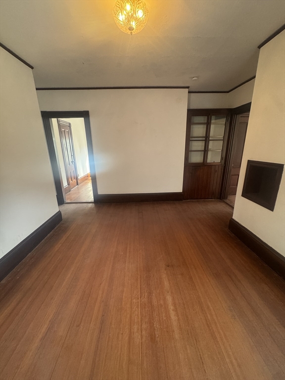 86 Chestnut Street, Unit 2 Brookline, MA 02445 - Photo 4 of 11 a view of a room with wooden floor and white walls