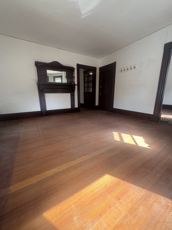 86 Chestnut Street, Unit 2 Brookline, MA 02445 - Photo 6 of 11 a view of an empty room with a fireplace and window