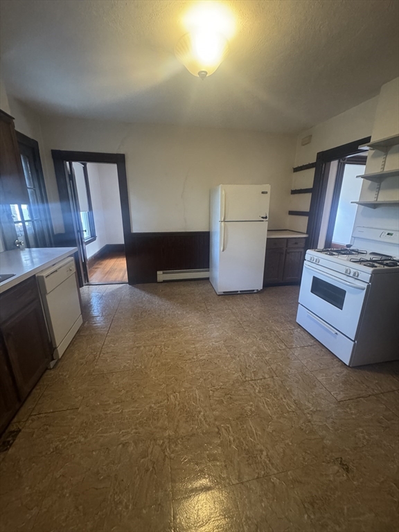 86 Chestnut Street, Unit 2 Brookline, MA 02445 - Photo 7 of 11 a view of an empty room with a fireplace