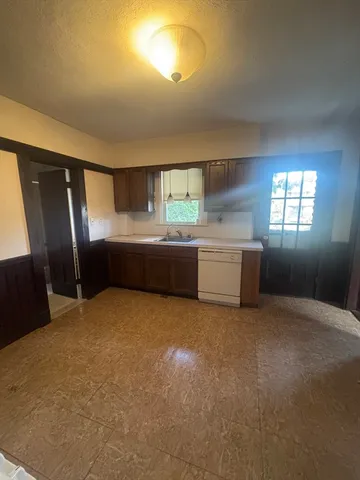 a kitchen with refrigerator and window