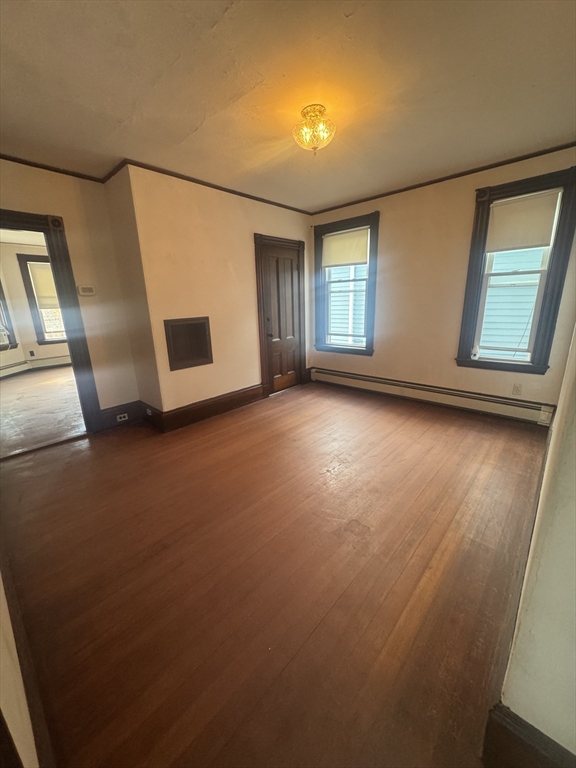 86 Chestnut Street, Unit 2 Brookline, MA 02445 - Photo 9 of 11 a view of a livingroom with wooden floor and window
