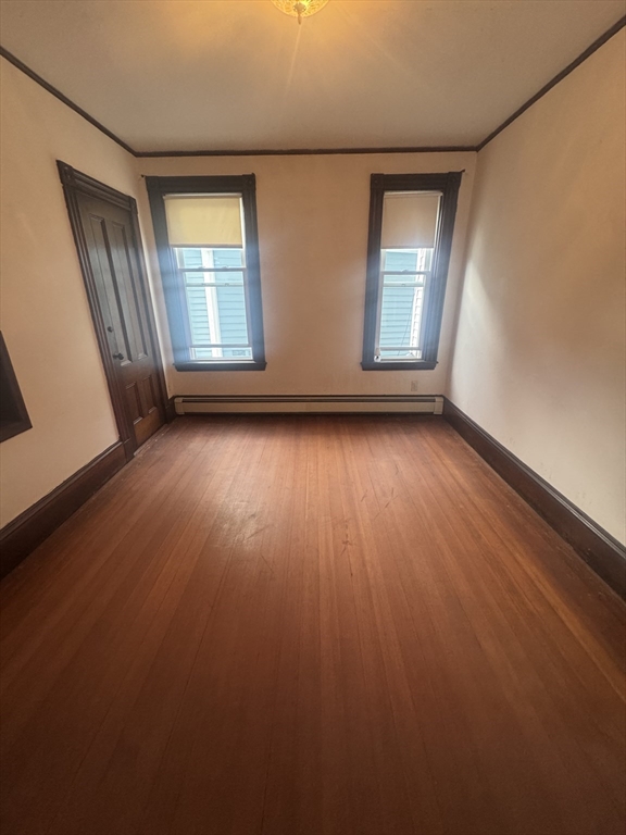 86 Chestnut Street, Unit 2 Brookline, MA 02445 - Photo 10 of 11 an empty room with wooden floor and windows