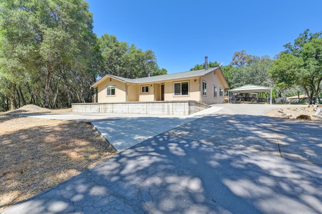 12244 Wolf Road Grass Valley, CA 95949 - Photo 1 of 1 a front view of a house with a yard and trees