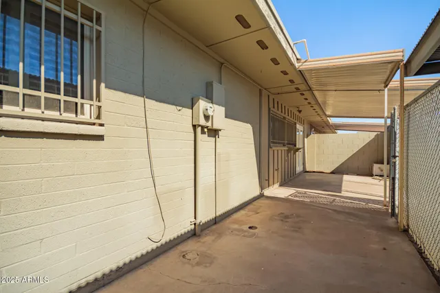 a backyard of a house with table and chairs