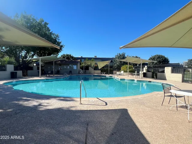 a view of backyard with a house and car parked in garage