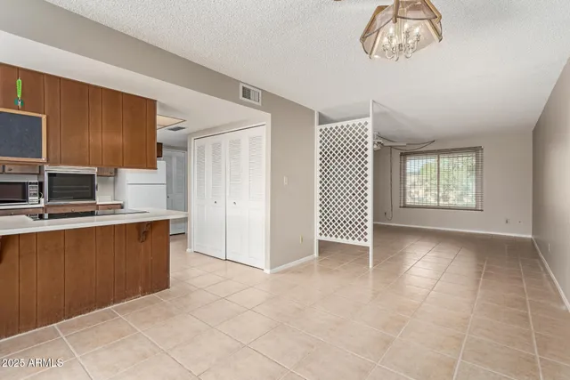 a kitchen with kitchen island granite countertop a sink stove and refrigerator