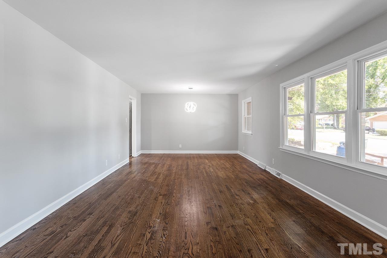 1307 Castlebay Road Durham, NC 27704 - Photo 21 of 41 an empty room with wooden floor and windows