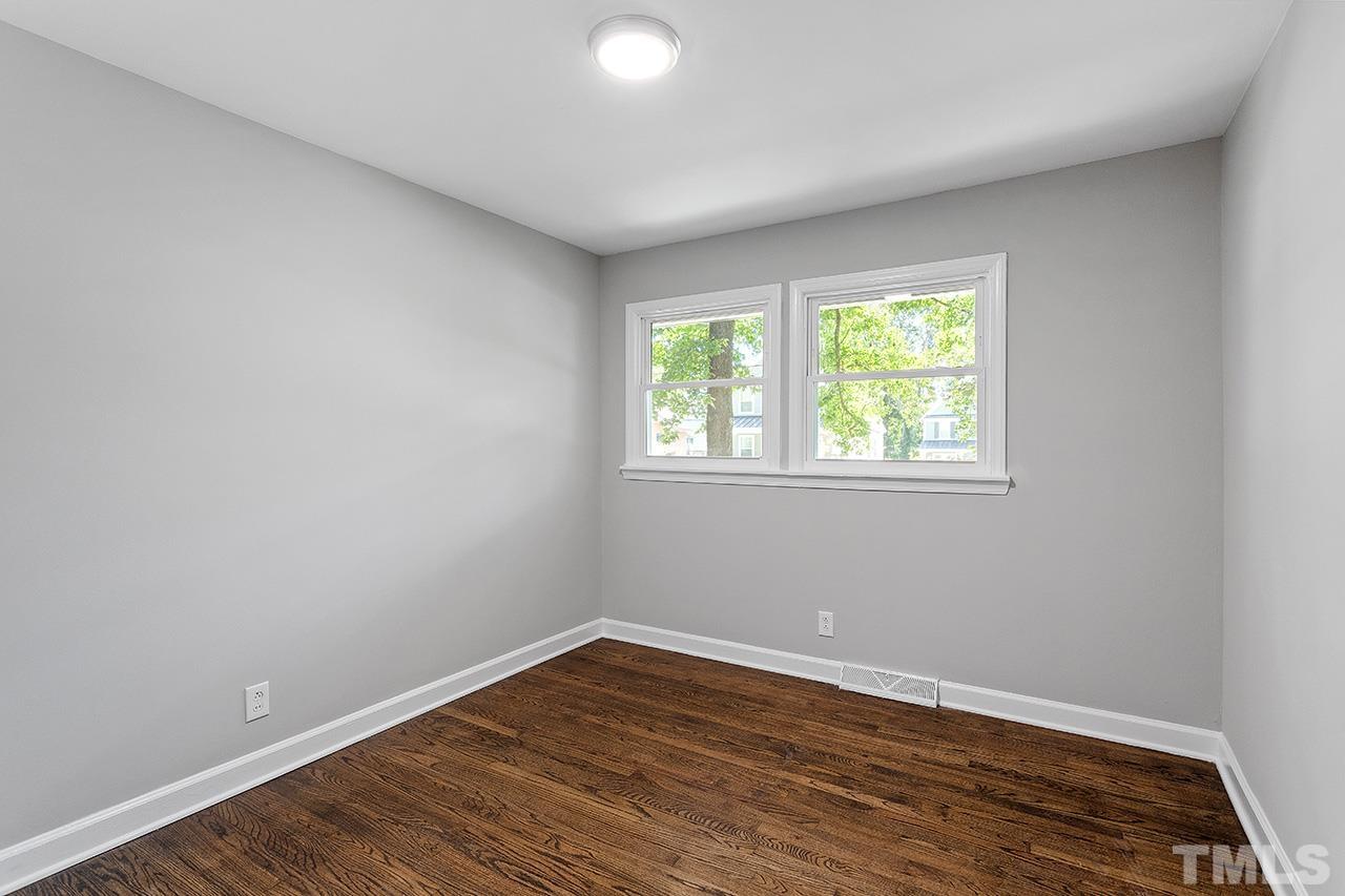 1307 Castlebay Road Durham, NC 27704 - Photo 26 of 41 a view of an empty room with wooden floor and a window
