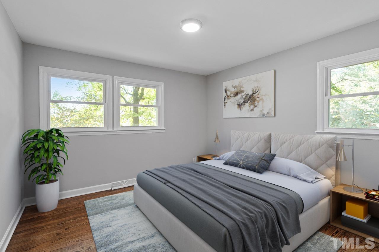 1307 Castlebay Road Durham, NC 27704 - Photo 8 of 41 a bedroom with a large bed and a potted plant