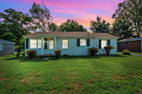 a front view of house with yard and green space