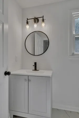 a bathroom with a sink and mirror