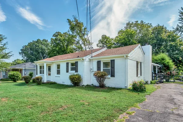a view of a house with backyard sitting area and garden