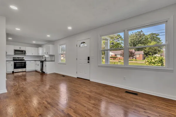 a view of kitchen with wooden floor and window