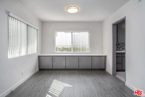 a kitchen with granite countertop a stove a sink and a window