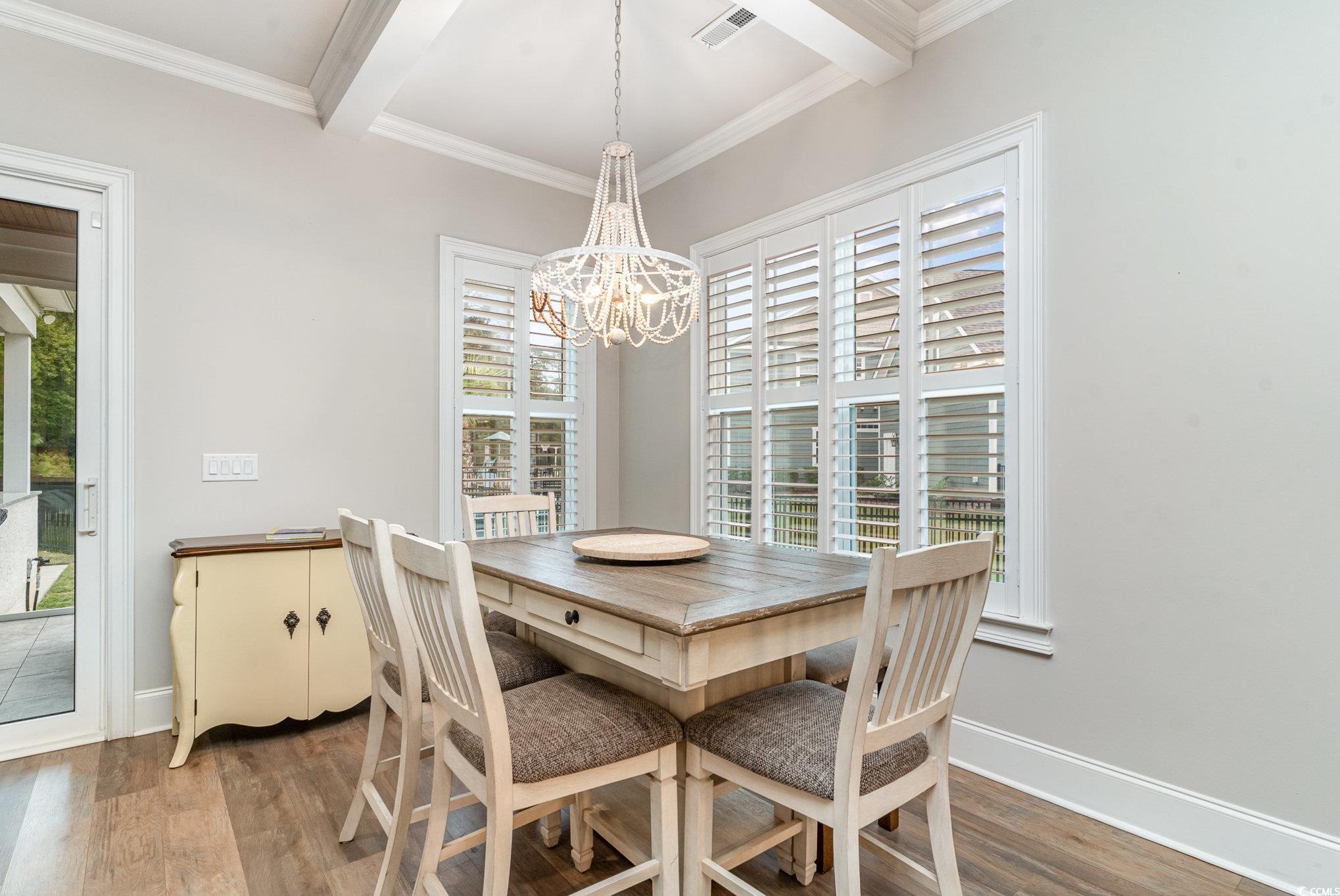 528 Starlit Way Myrtle Beach, SC 29579 - Photo 11 of 40 Dining area featuring an inviting chandelier, beam