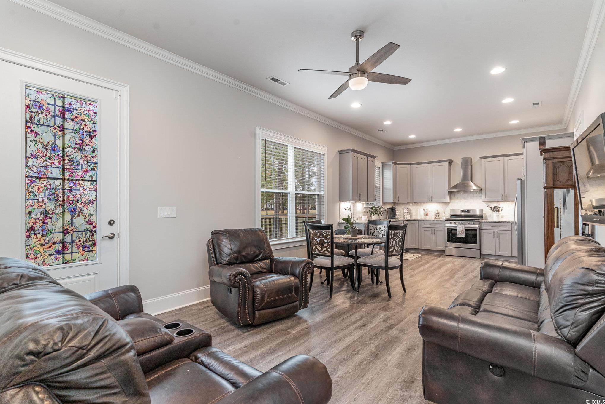 528 Starlit Way Myrtle Beach, SC 29579 - Photo 15 of 40 Living room featuring crown molding, light hardwoo