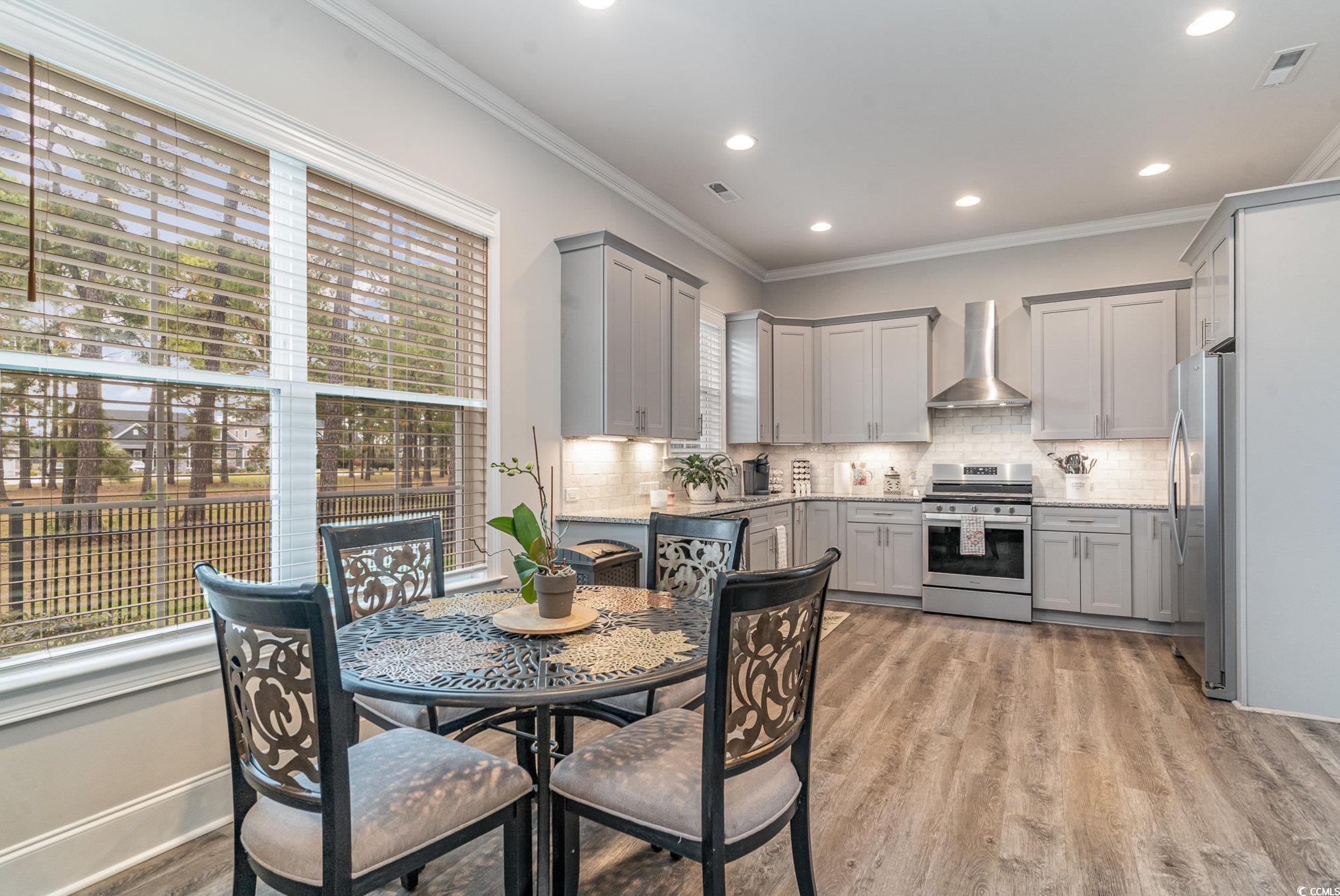 528 Starlit Way Myrtle Beach, SC 29579 - Photo 17 of 40 Kitchen with gray cabinetry, wall chimney range ho