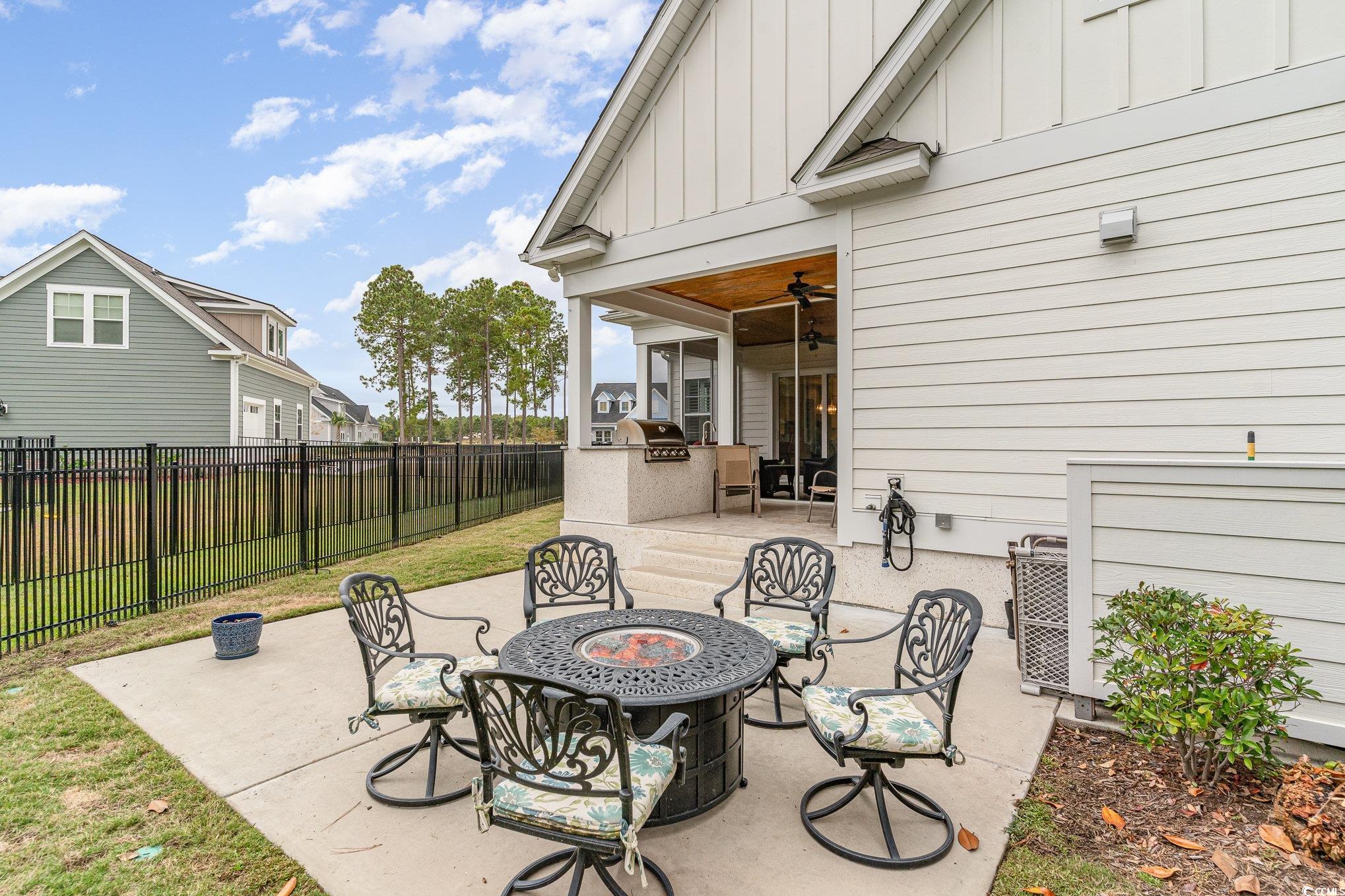 528 Starlit Way Myrtle Beach, SC 29579 - Photo 32 of 40 View of patio with ceiling fan, an outdoor fire pi