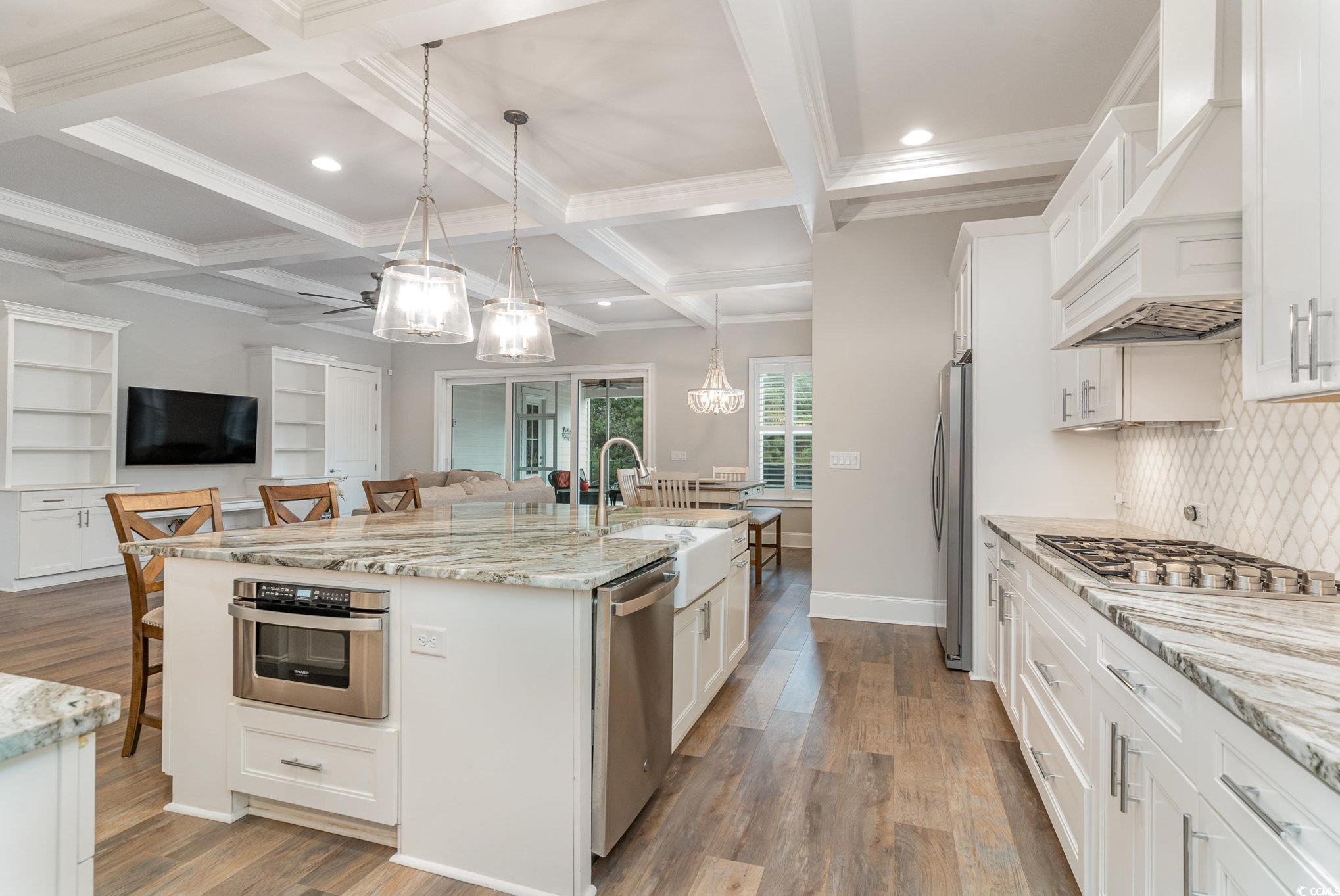 528 Starlit Way Myrtle Beach, SC 29579 - Photo 9 of 40 Kitchen featuring white cabinets, a center island