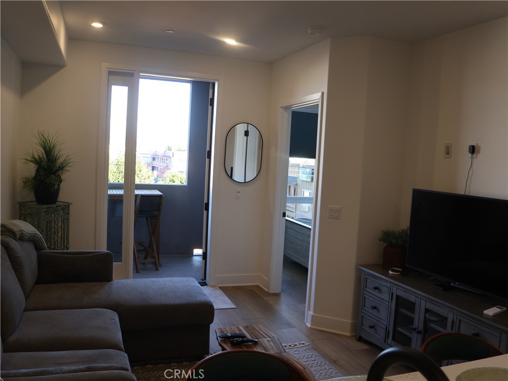 402 West Grand Avenue, Unit 302 Grover Beach, CA 93433 - Photo 4 of 10 a living room with furniture and a flat screen tv