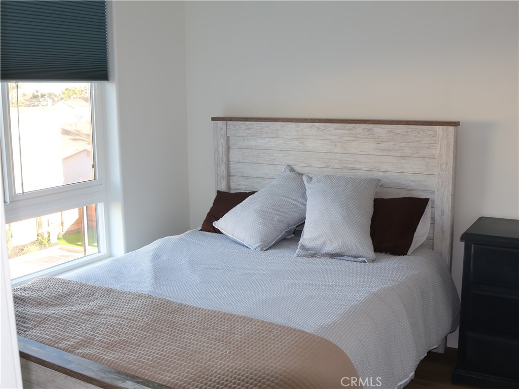 402 West Grand Avenue, Unit 302 Grover Beach, CA 93433 - Photo 6 of 10 a bedroom with a bed and a window
